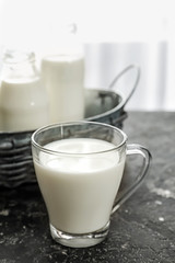 Glass cup of fresh milk on table