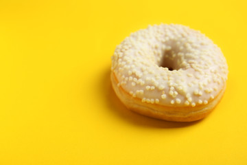 Sweet tasty donut on color background
