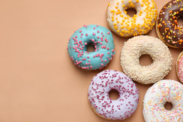 Sweet tasty donuts on color background