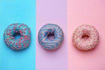 Sweet tasty donuts on color background