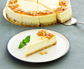 Cheesecake with caramel and peanuts. Slice.