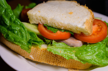 Homemade sandwich with lettuce, cucumber and tomato. Selective focus.