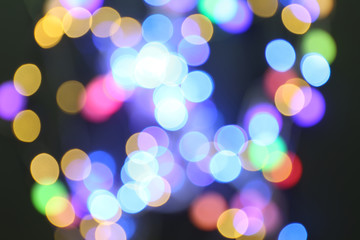Blurred view of glowing lights on dark background