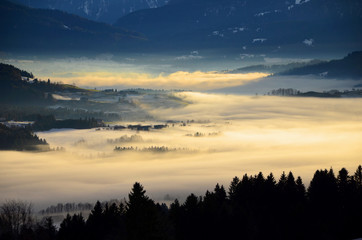 Fototapeta na wymiar Light falling on fog in valleys of Alpine Foothills in Bavaria seen from Sulzberg, Austria