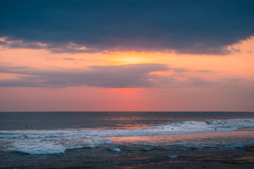 Fototapeta na wymiar Natural Sunset Sunrise Over Teal Ocean. Bright Dramatic Sky And Dark Surfing Background. Ocean Landscape Under Scenic Colorful Sky At Sunset Dawn Sunrise. Sun Over Skyline, Horizon. Warm Colors. Surf