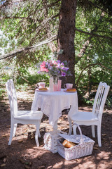 white chairs with table stand in  garden