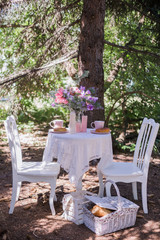 white chairs with table stand in  garden