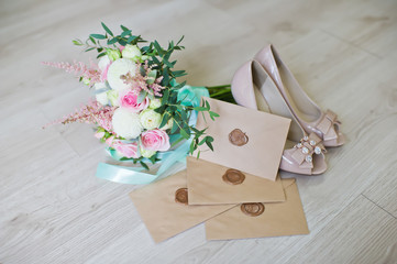 wedding bouquet of the bride, shoes, envelopes with invitations