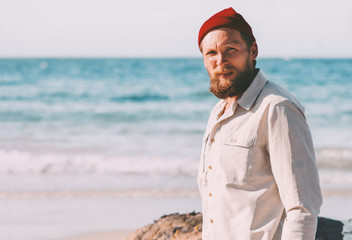 Handsome beard man walking on ocean beach summer traveling vacations trip fashion lifestyle...