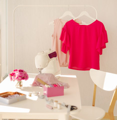 Workplace for sewing and needlework in a bright room with white furniture.