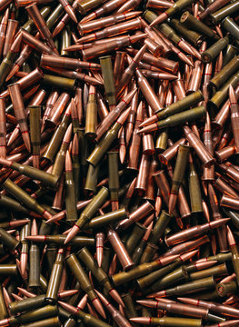 Different ammo on wooden background.