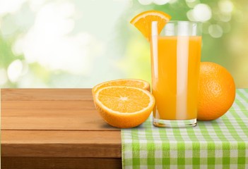 Orange juice and slices of orange on background