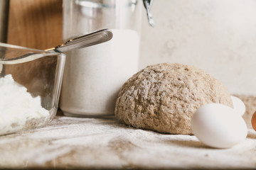 Kitchen still life. Dough, flour and eggs are on tabletop