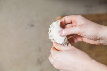 hands of  woman make  dumpling