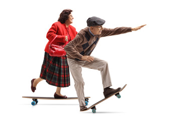 Elderly lady and an elderly man riding a longboard © Ljupco Smokovski