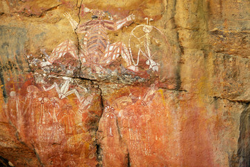 Ancient aboriginal painting of man art on huge rock stone in Kakadu park, northern territory, Australia.