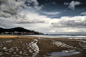 Landscape of beach, mountain and cloudy sky