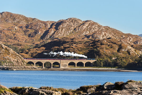 Jacobite Steam Train at a Viaduct in Scottish Highlands