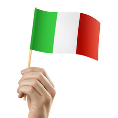 Hand holding flag of Italy, isolated on white background