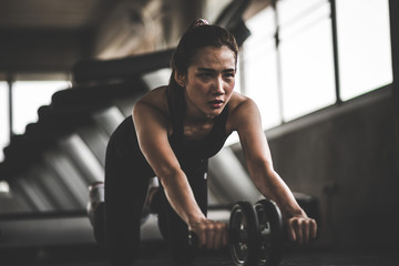 Fototapeta na wymiar woman exercising building muscles at gym