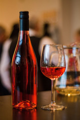 A bottle of wine with a glass