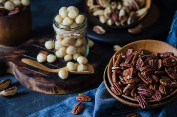 Fototapeta na wymiar Variety of nuts: macadamia, pecan and brazil nuts in rustic style