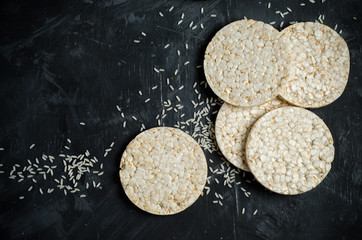 Rice cakes on black background with space for text