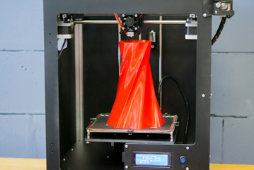3D printer working close up. Automatic three dimensional 3d printer performs plastic. Modern 3D printer printing an object from the hot molten. Concept progressive additive technology for 3d printing.