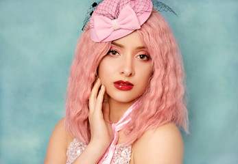 Young elegant woman with pink hair studio portrait