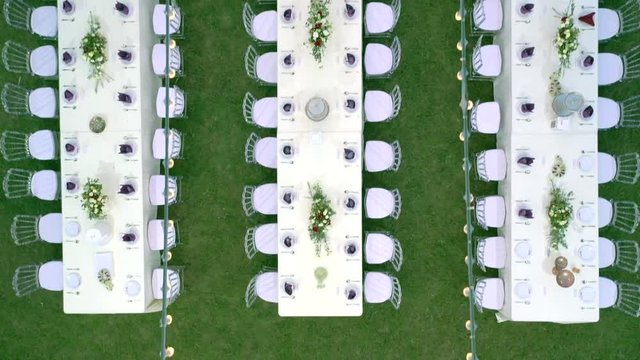 Dinner Corporate Party preparation set for dinner in the garden, Shooting from the Topview.