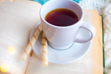 white cup on the book. Romantic breakfast in bed for Valentine's Day or Mother's Day
