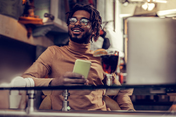 Pleased bearded freelancer dreaming about active weekends