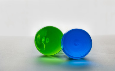 Two glass spheres close up on a light background.