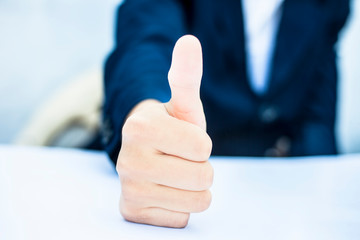 Close up of hand of business man showing thumbs up or showing happiness via hand gesture isolated on white.