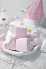 Pink and White Marshmallow  marshmallow in heart shape on the  table . Pastel color dessert. Selective focus. Soft focus
