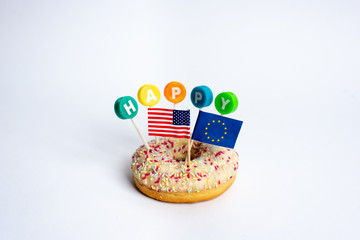 a colorful donut with the word HAPPY and European Union with United States flags on a white background
