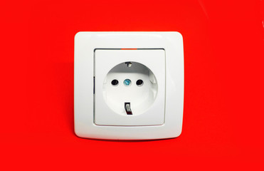 white electrical outlet on isolated red background