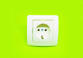 white electrical outlet on isolated lime green background