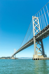 Fototapeta na wymiar looking up at the San Francisco Bay Bridge from the water