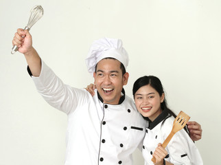 Naklejka premium Funny Asian chef holding spatula for battle with food together, lifestyle concept.