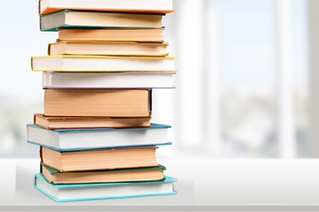 Colorful books collection on background.