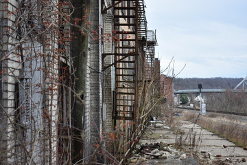 Depressed northern rust belt town with abandoned brick buildings, bridge  and weeds in Brownsville Pennsylvania