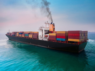 Fototapeta premium The container vessel departure from port of Thailand after completed loading.