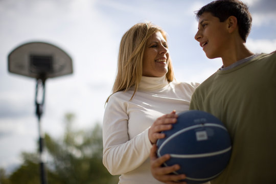 Mother and son on basketball court