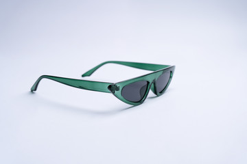 Green sunglasses with black plastic frame isolated on white background