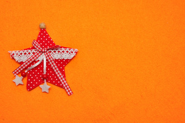 Fototapeta na wymiar A red star on an orange background