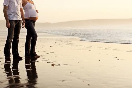 Expectant parents looking out to sea