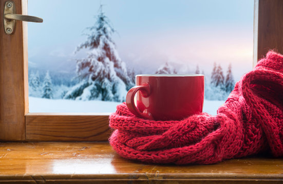 Cup of coffee or tea, smartphone and earbuds with autumn leaves near a window. Autumn playlist concept. Autumn music for rainy days. - Powered by Adobe