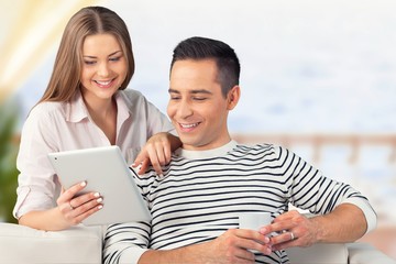 Young business couple using laptop at home, online shopping with