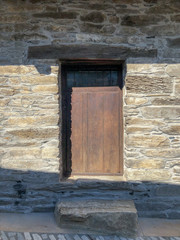 SPAIN, LEON, PENALBA DE SANTIAGO - Jul 27, Ancient wooden door in stone house wall